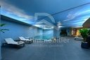 Piscine intérieure du spa avec transats et plafond décoré d’un ciel